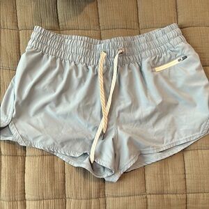 Vuori Blue Athletic Shorts with Relaxed Fit and Curved Hem